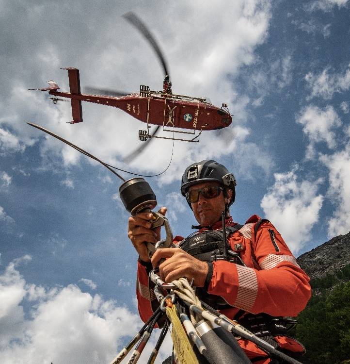 Man in radio rig, rigging up to a helicopter