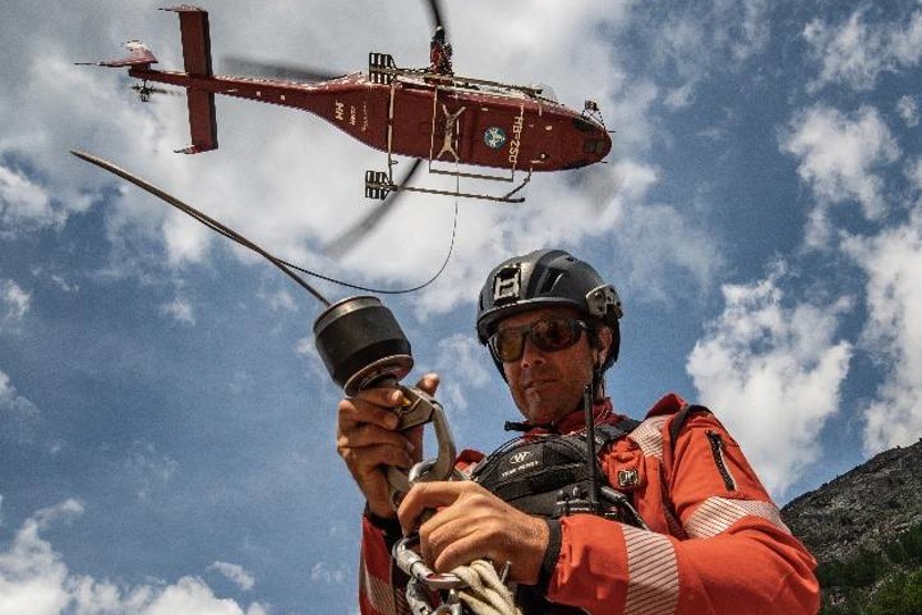 Man in radio rig, rigging up to a helicopter