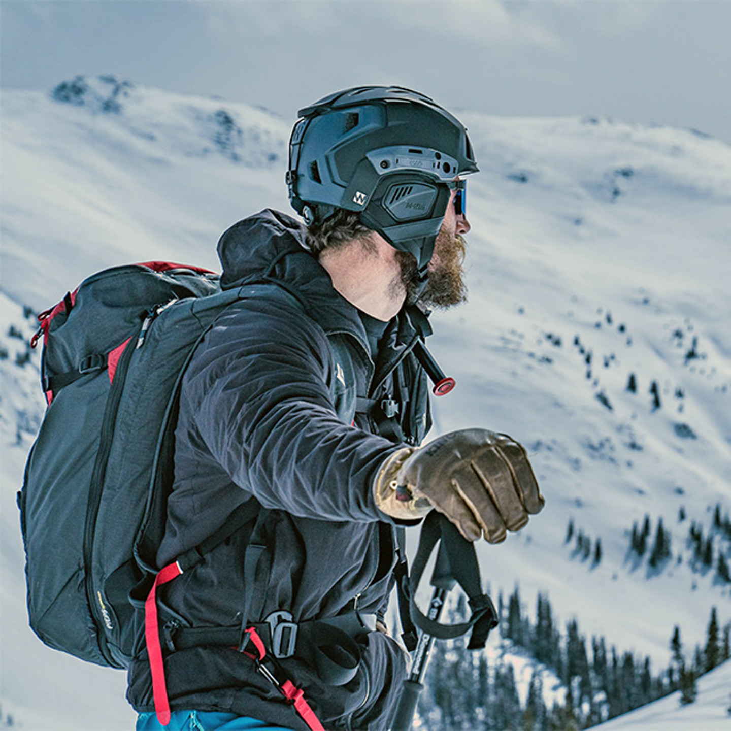 Man in snow covered mountains wearing helmet
