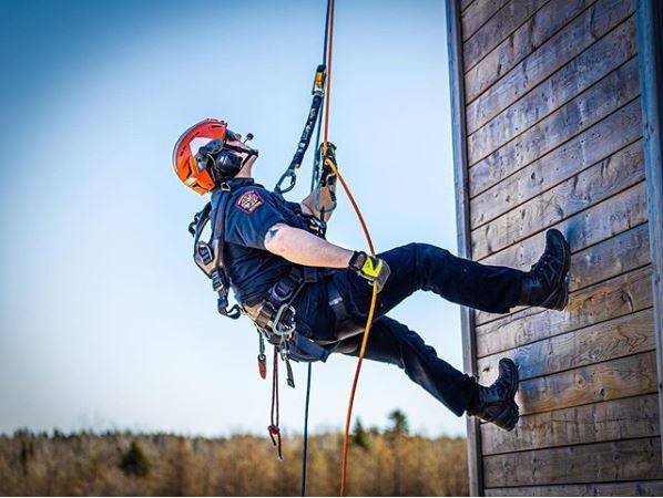 Man abseiling down a wall 
