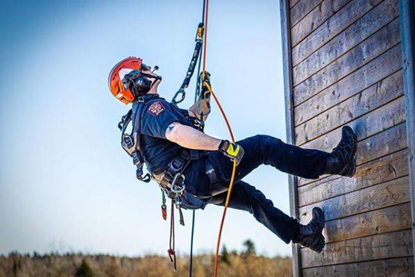 Man abseiling down a wall
