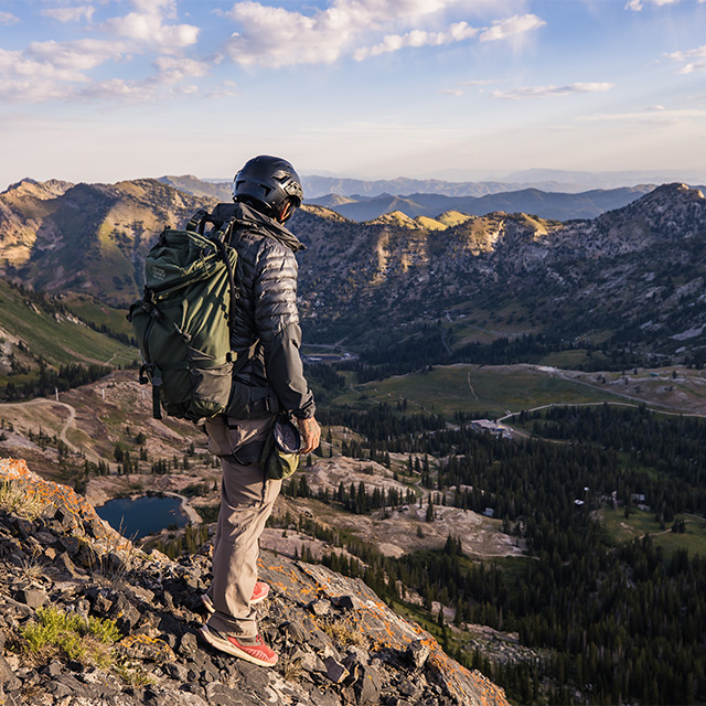 Man on top of a mountain wearing a helmet