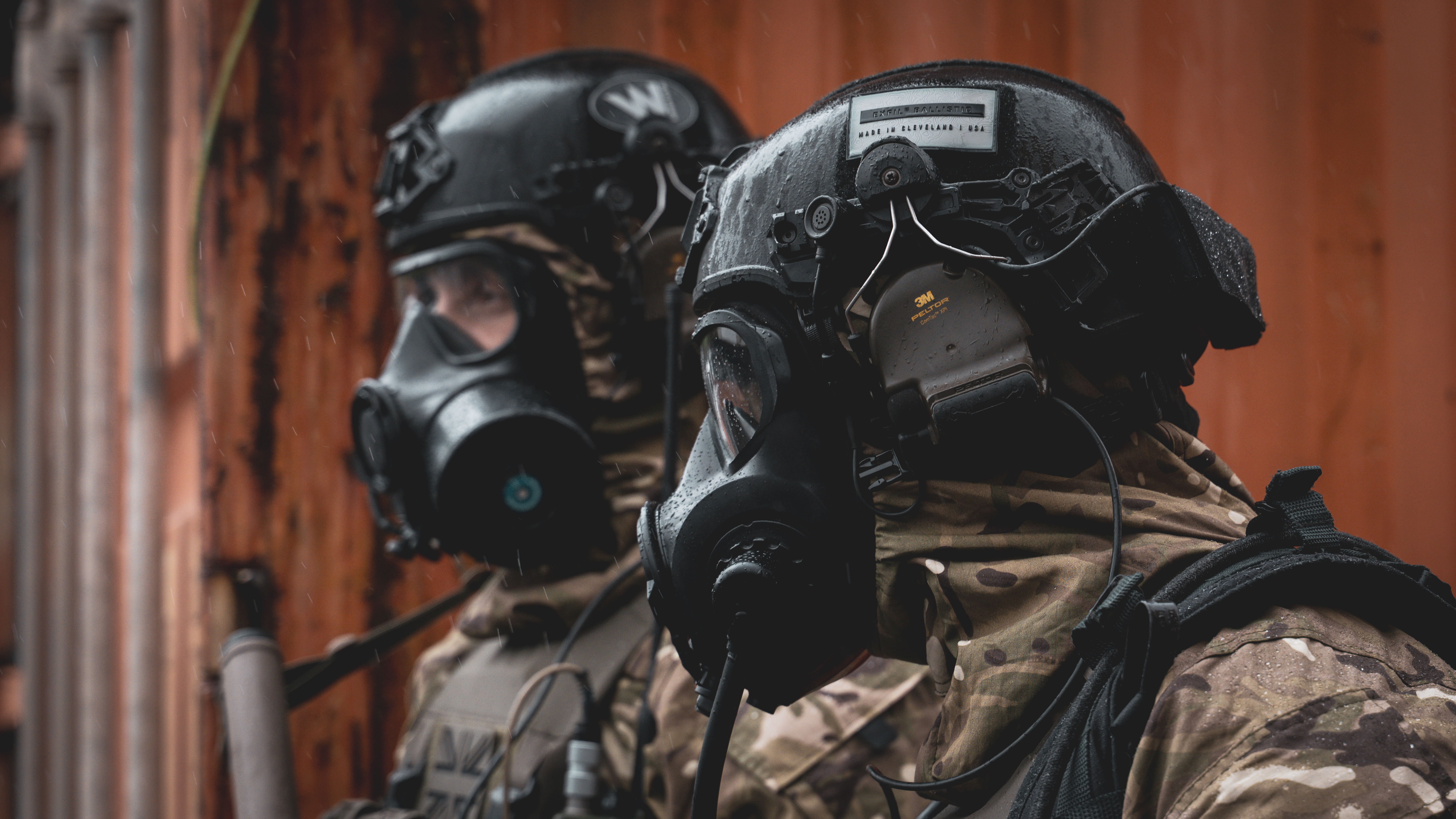 2 soldiers in CBR attire including a Team Wendy ballistic helmet and Avon Protection respirator
