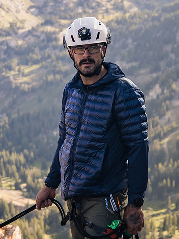 Man with white helmet on holding a rope