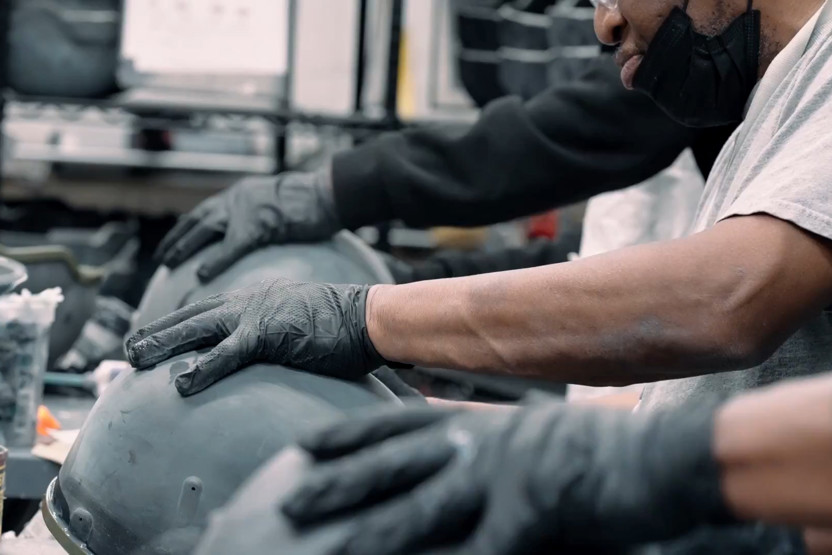 Gloved hands working on manufacturing