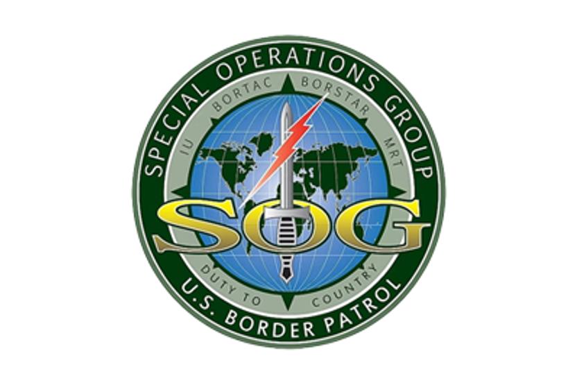 Logo for the United States Border Patrol's Special Operations Group. It shows a globe with the letters SOG with a sword and a red lightening bolt.