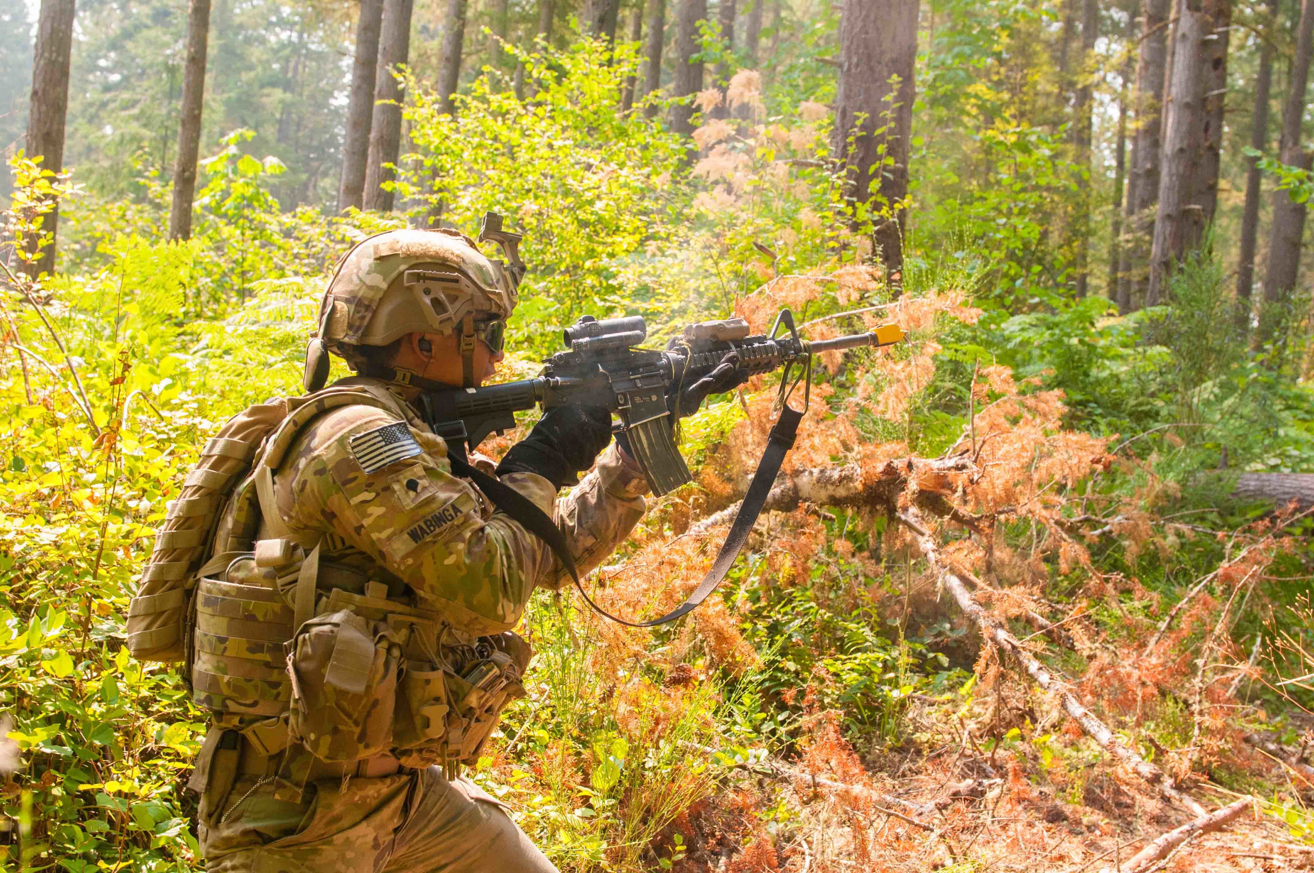 Soldier In Forest Wearing Integrated Head Protection System helmet