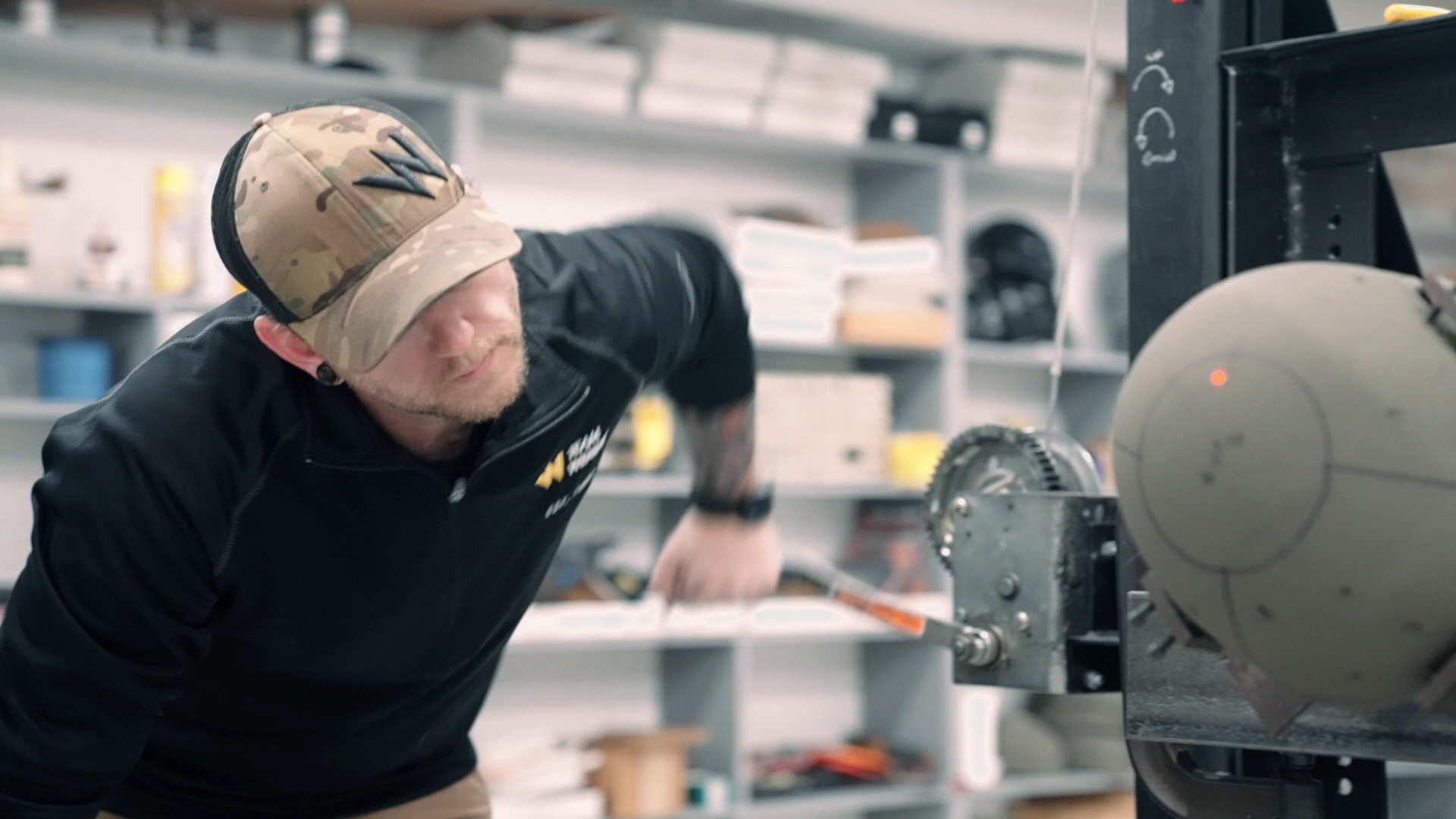 Man in cap working with machinary