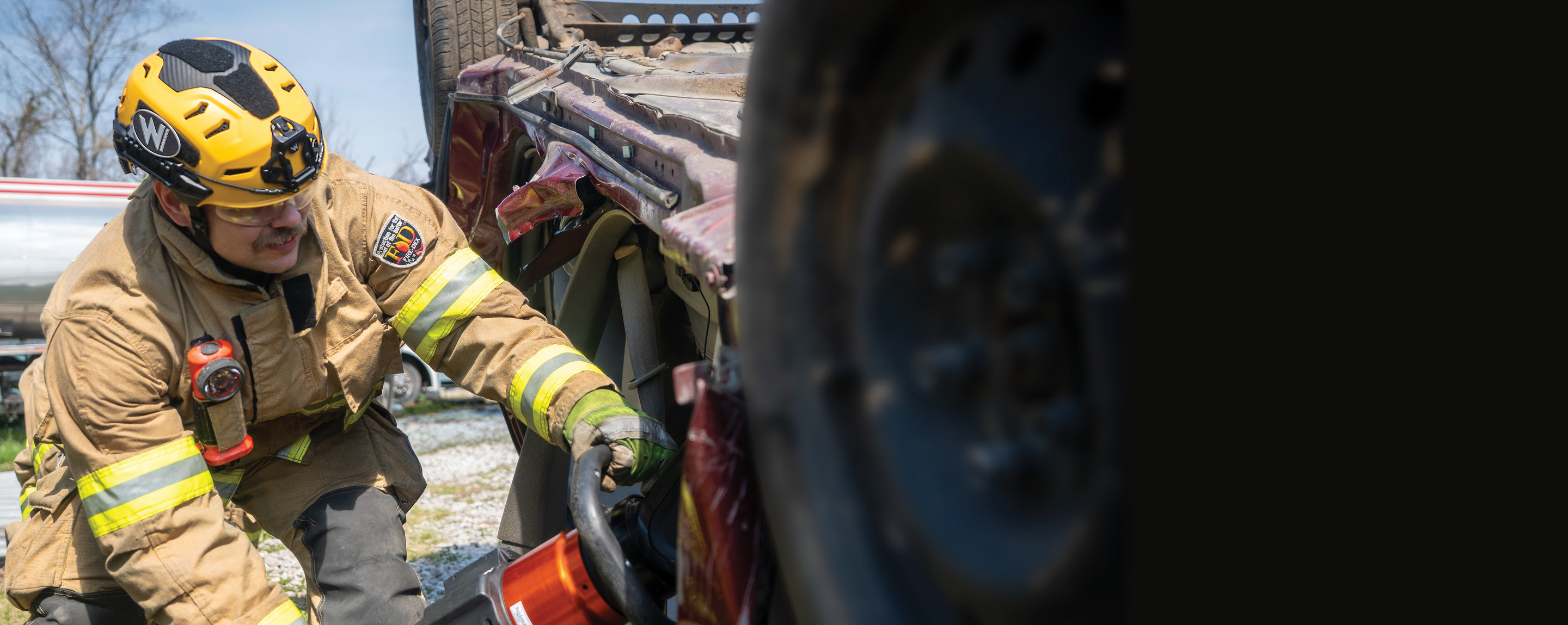 A firefighter wearing a Team Wendy RECON Tactical helmet during a vehicle extrication
