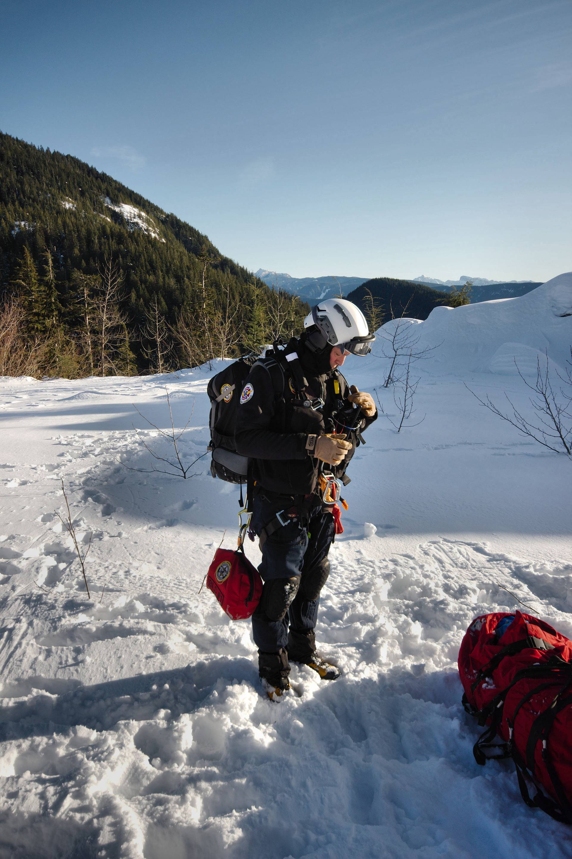 Man wearing harnesses and helmet in the snow