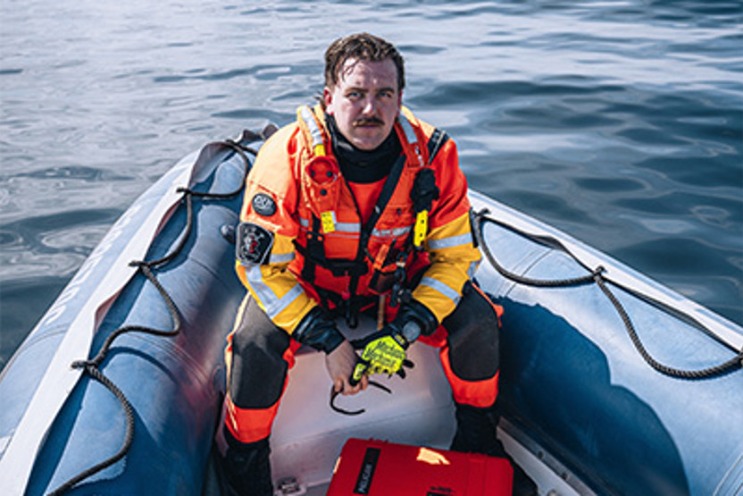 Man in high vis suit on boat