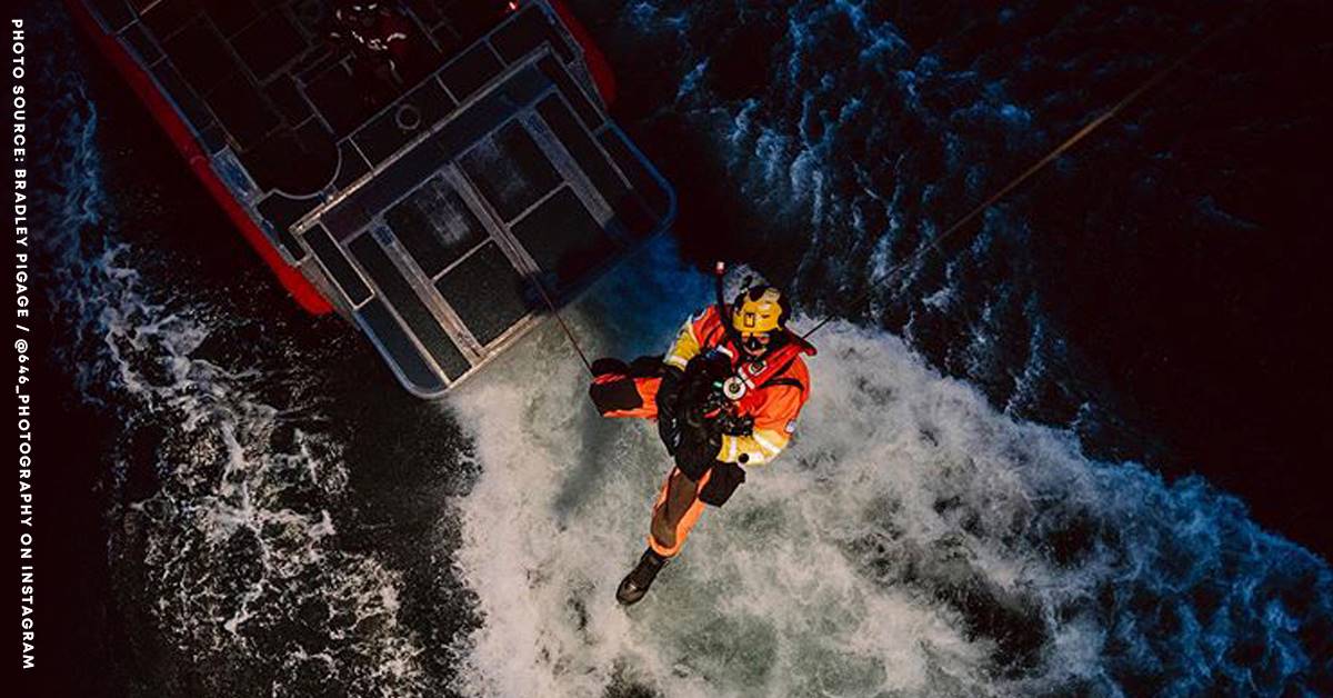 USCG RESCUE SWIMMERS lowered into the sea