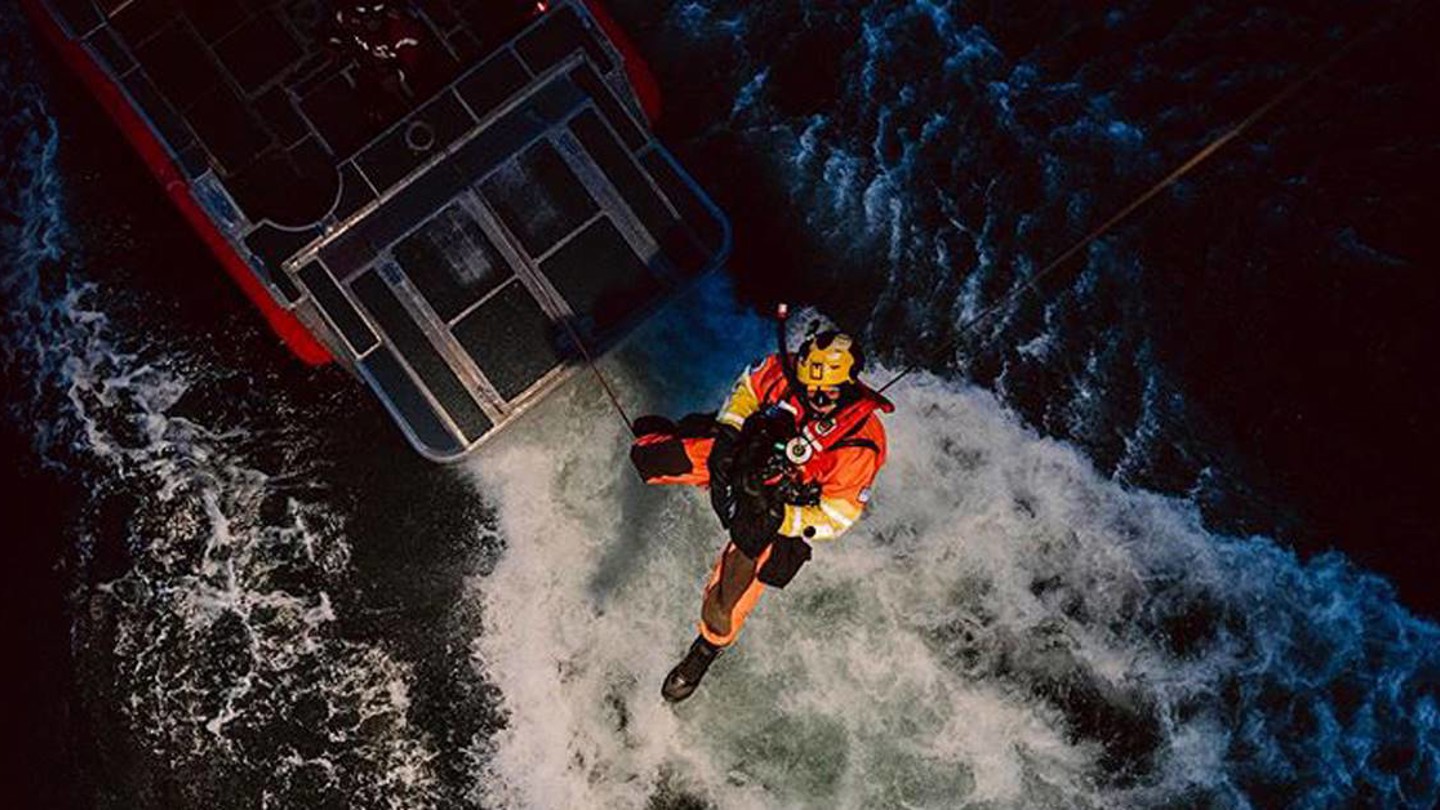 USCG RESCUE SWIMMERS lowered into the sea