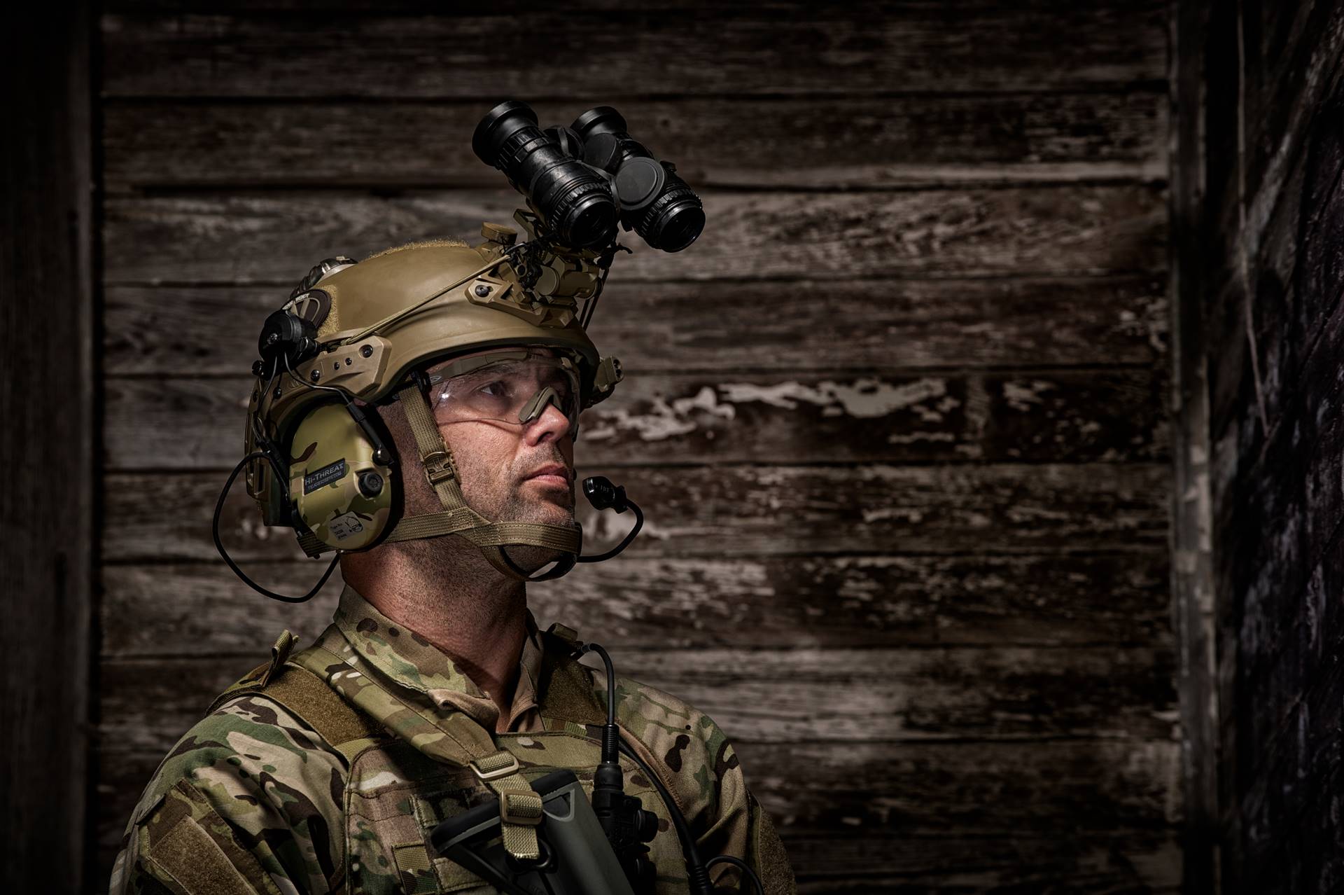 Man in camo with helmet and helmet accessories on