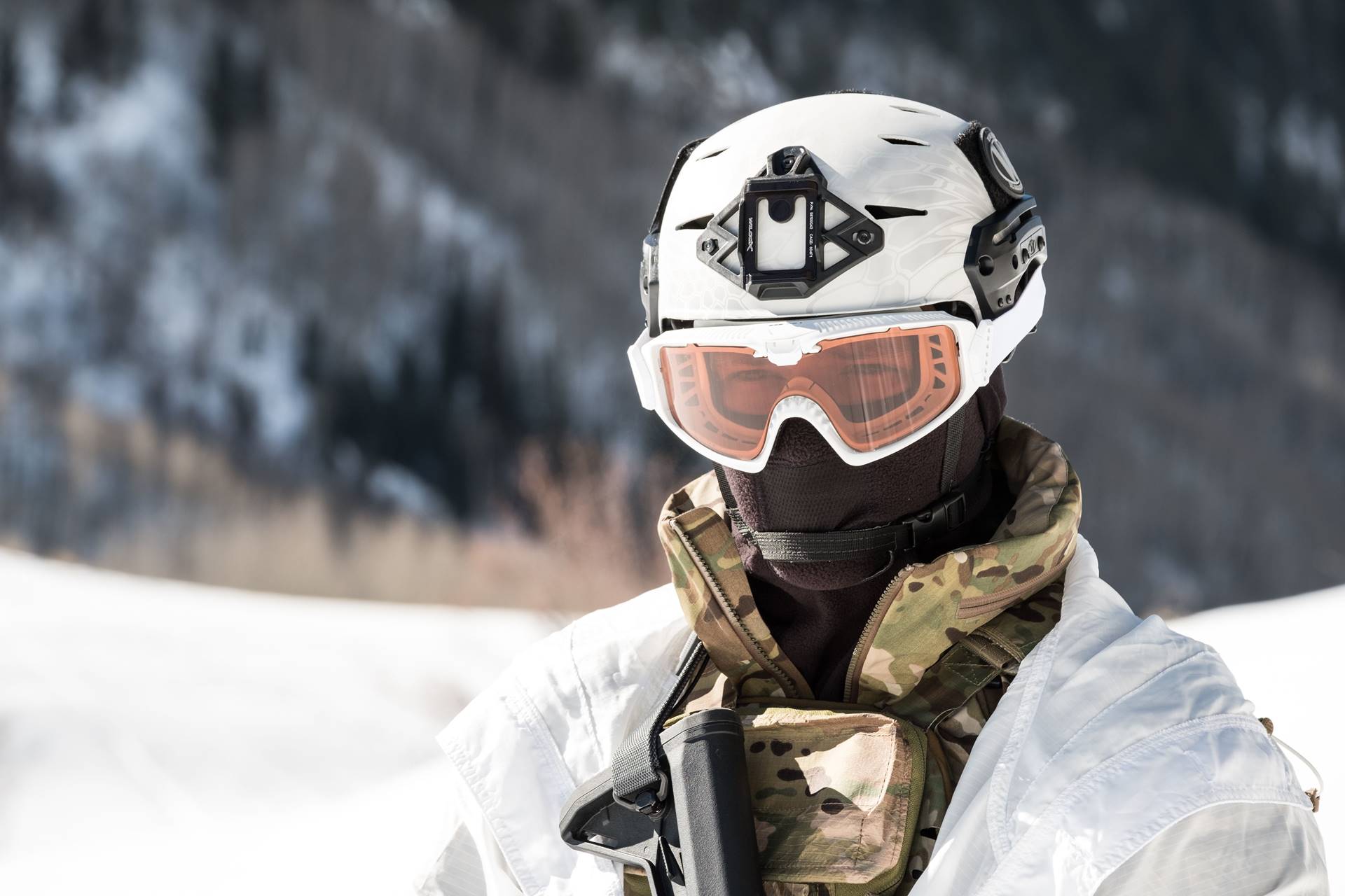 Man wearing ski goggles and a white helmet