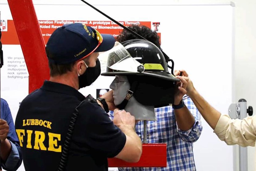 People wearing masks inspecting a helmet on a dummy head
