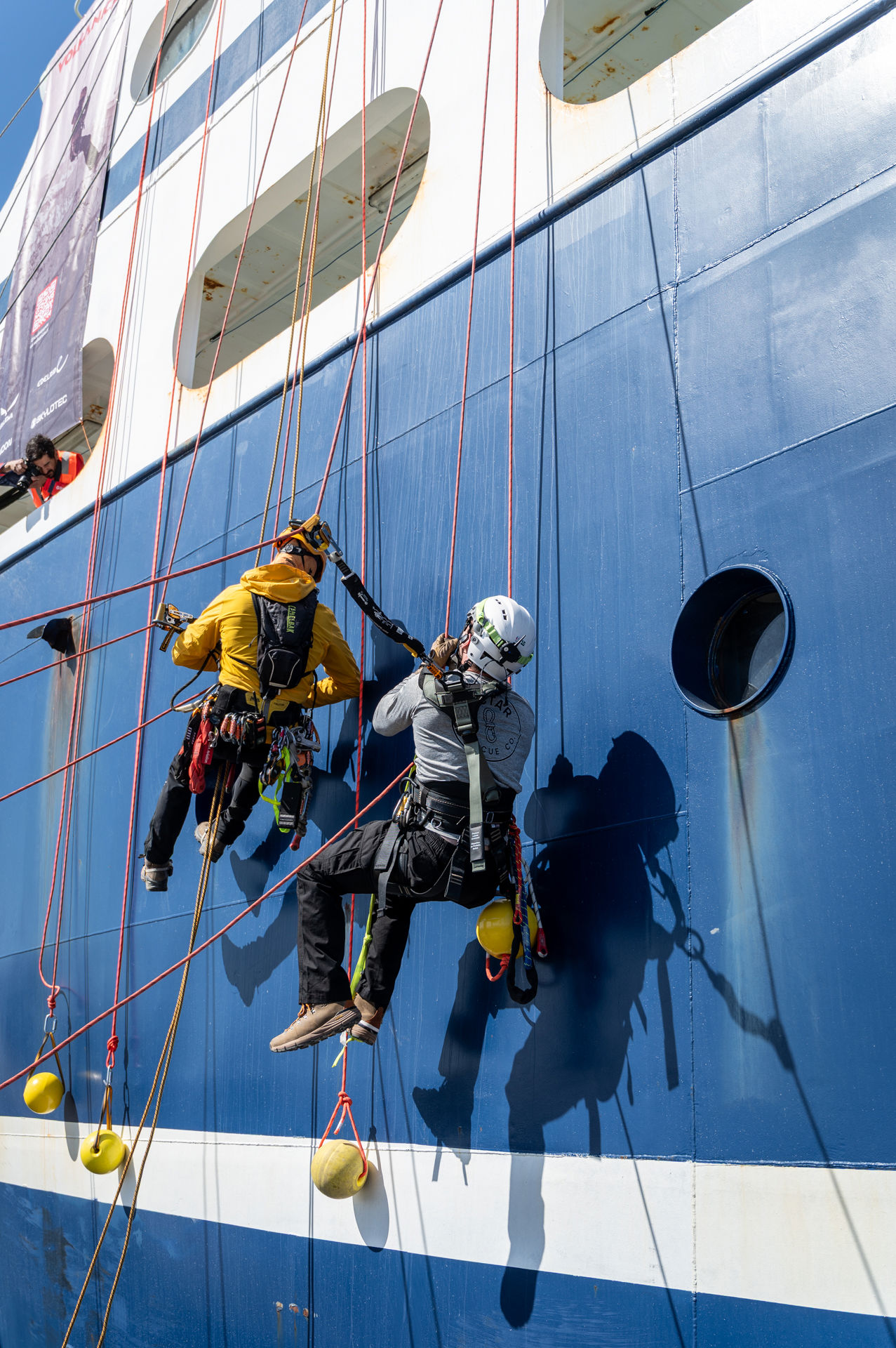 Nectar Rescue team scaling the side of a ship
