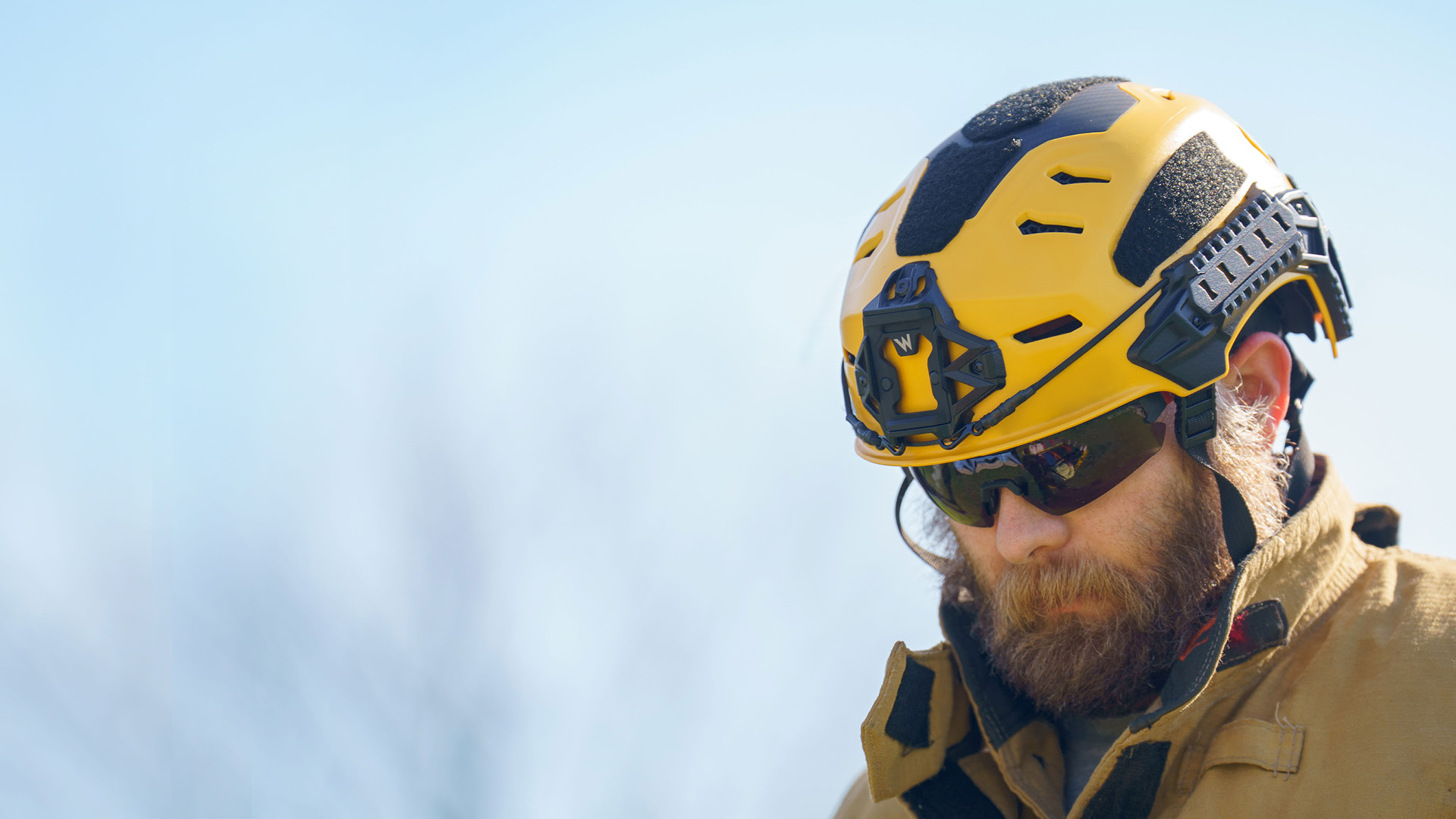 Firefighter wearing a yellow Team Wendy RECON Tactical helmet