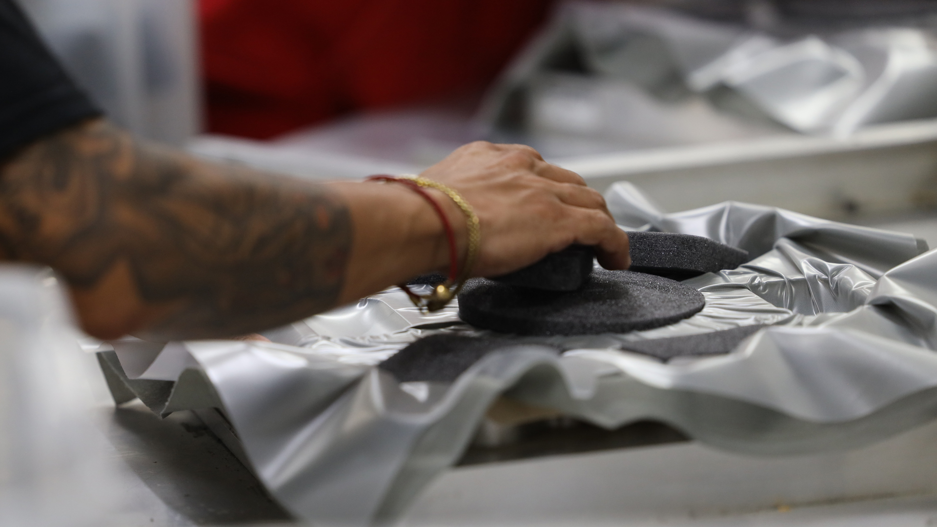 Close up of hands working in factory environment