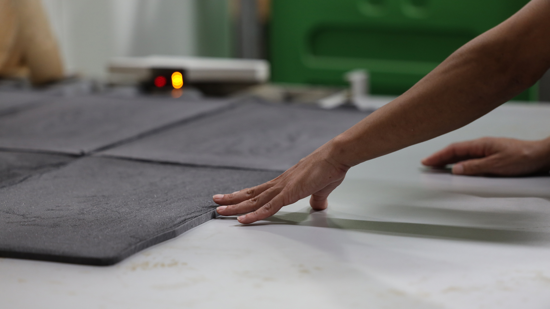 Close up of hands working with materials in factory