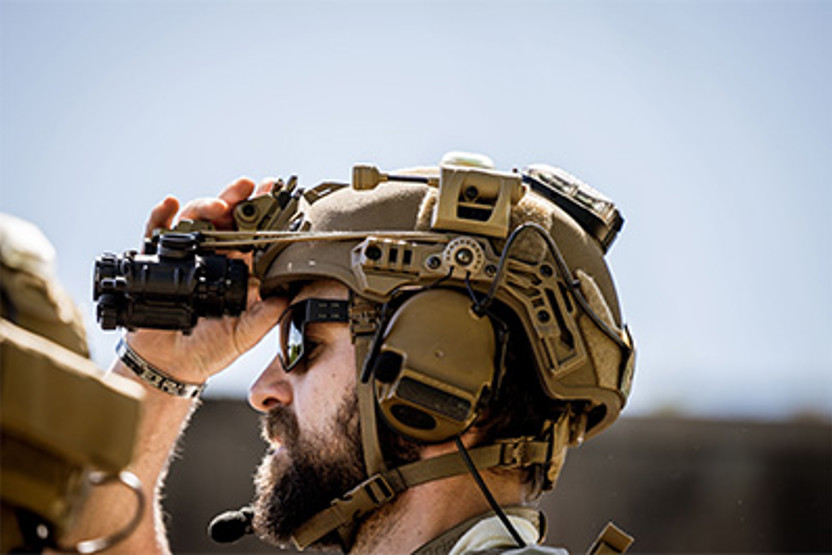 Man wearing helmet and binoculars