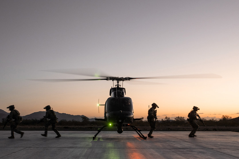 Image of soldiers either side of helicopter