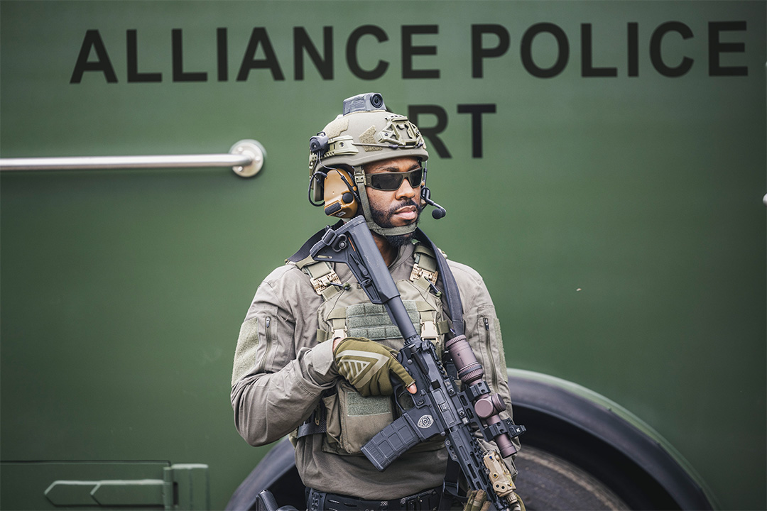 Image of man in camo holding a gun