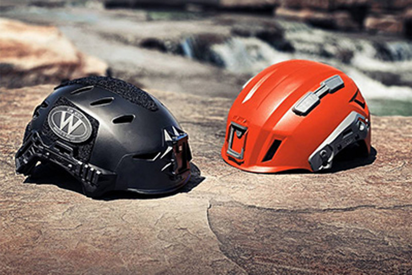 B;ack and orange helmet on rock