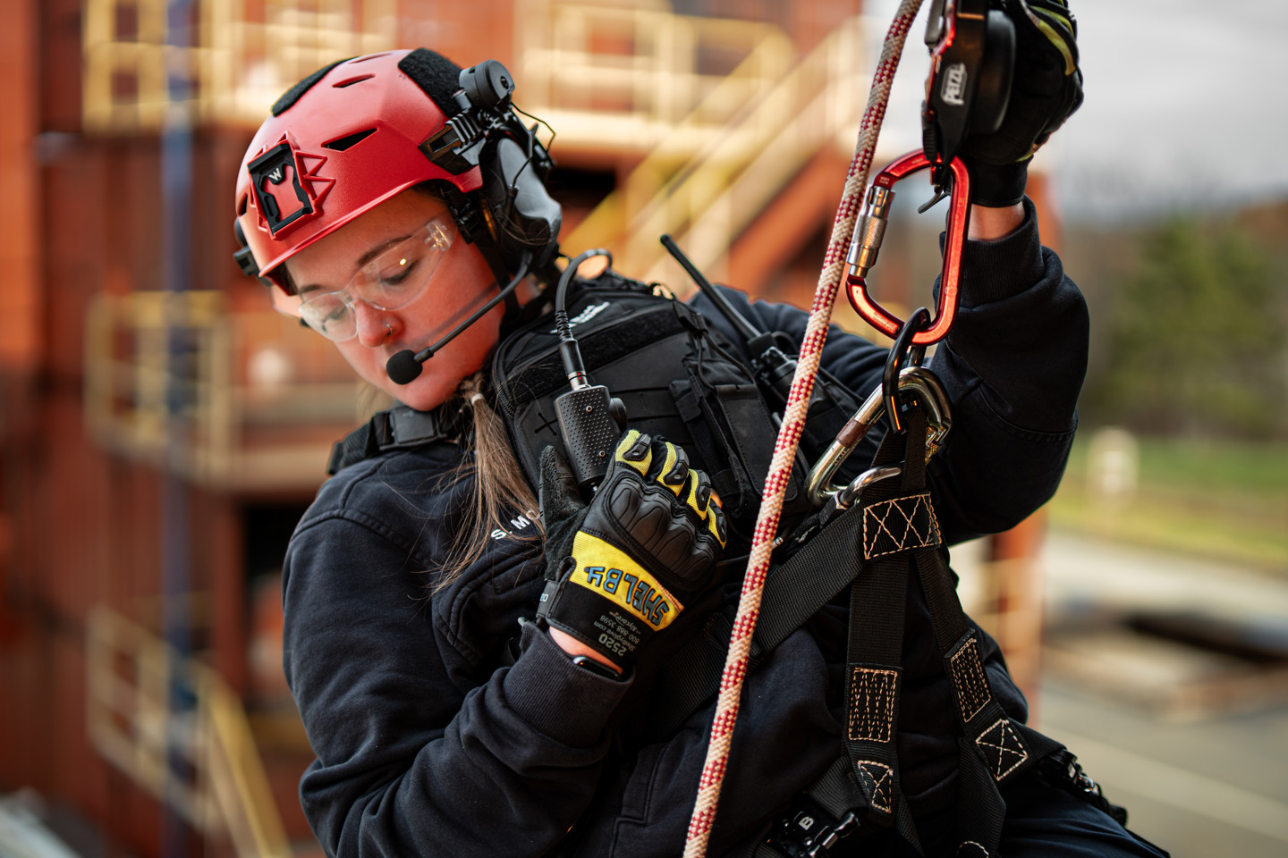 A search and rescue professional rappelling down a building wearing a Team Wendy EXFIL Rescuer helmet