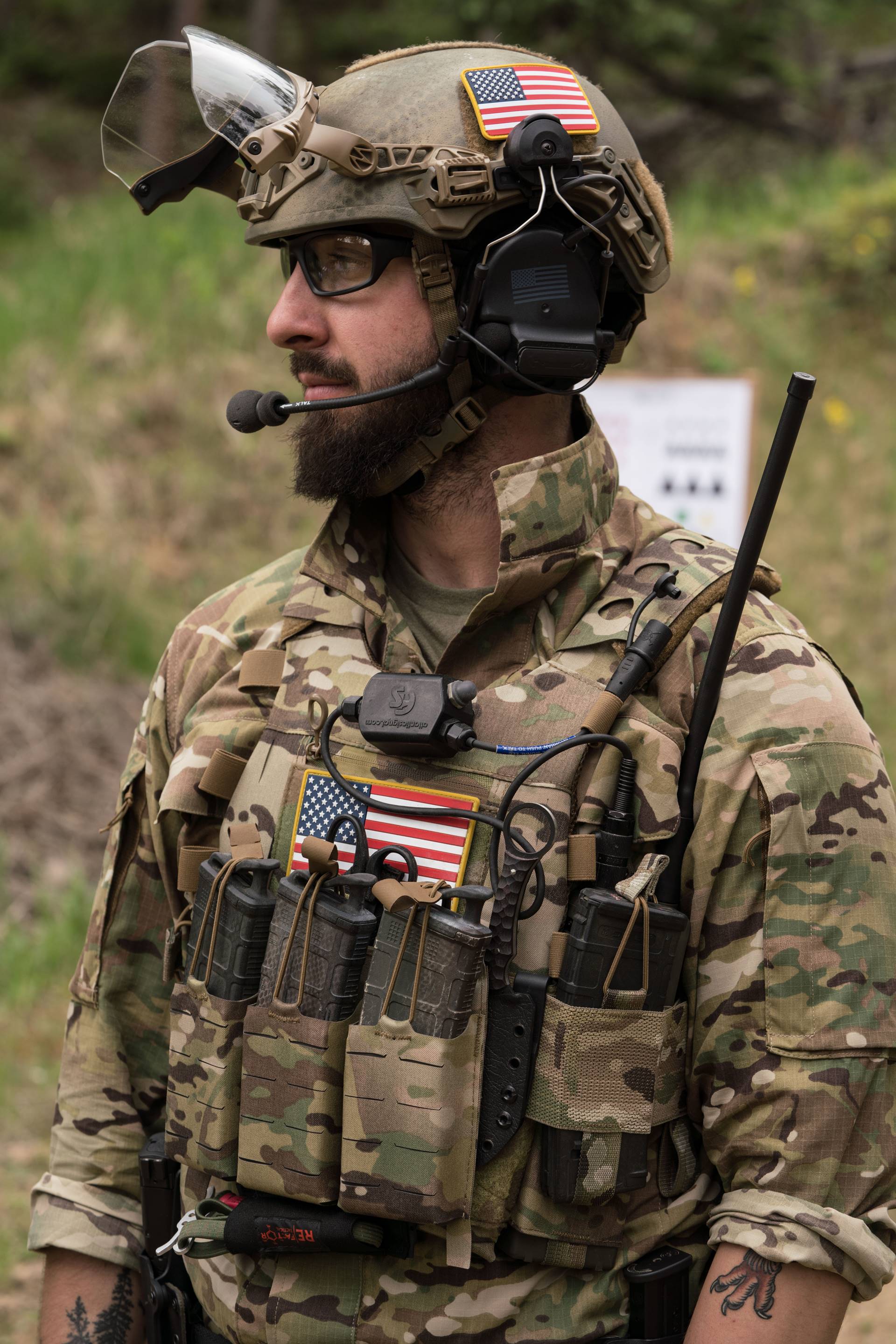 Man in camo with radio rig and helmet on
