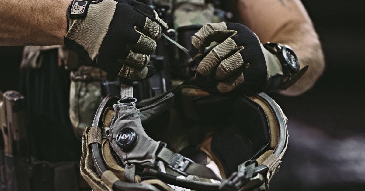 Image of soldier adjusting helmet fit