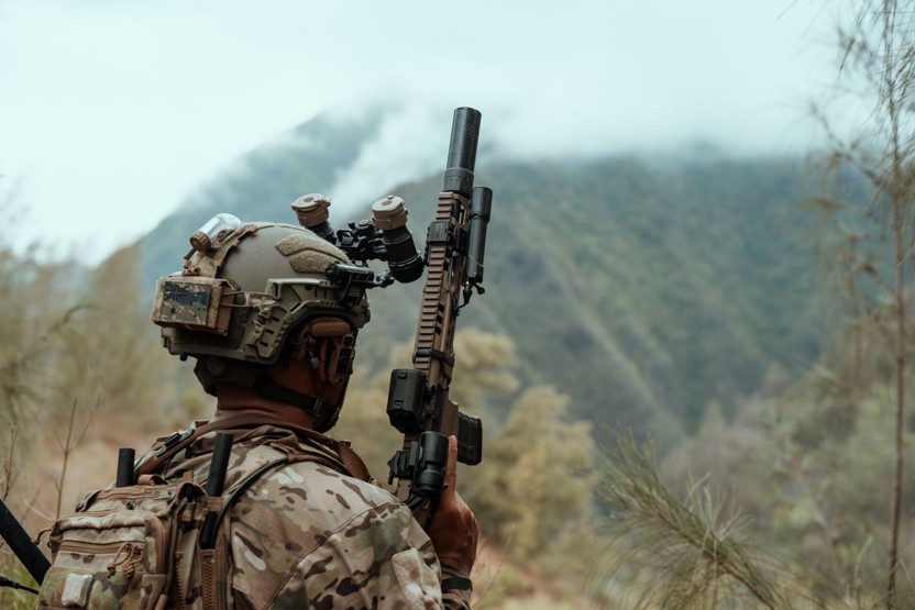 Soldier wearing a Team Wendy RIFLETECH rifle-rated ballistic helmet in a jungle setting