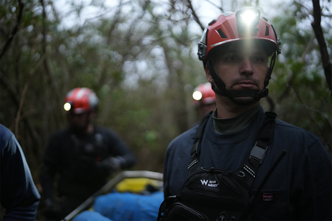 Man wearing helmet with head torch on